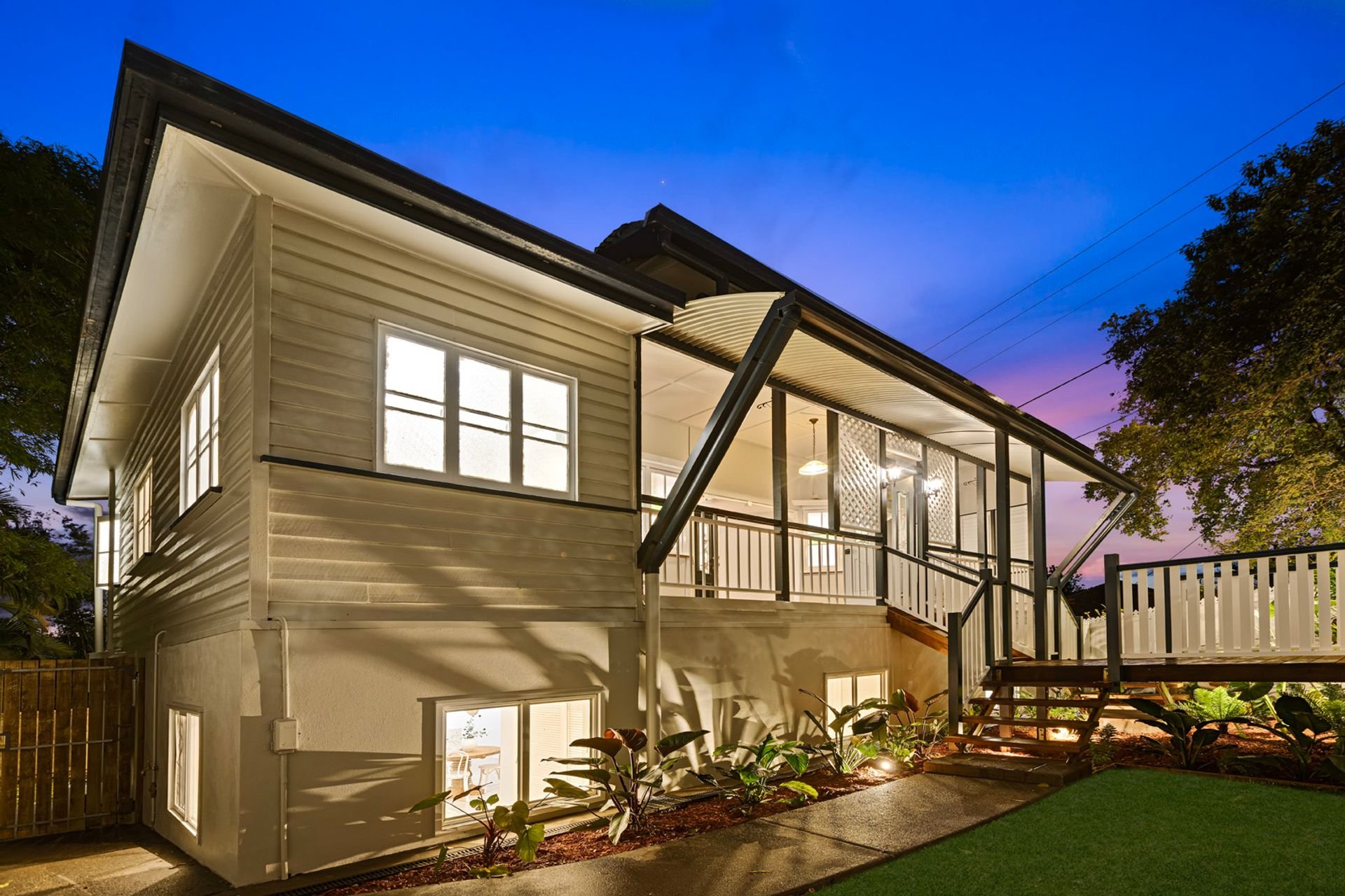 A stunning family Queenslander behind the white picket fence