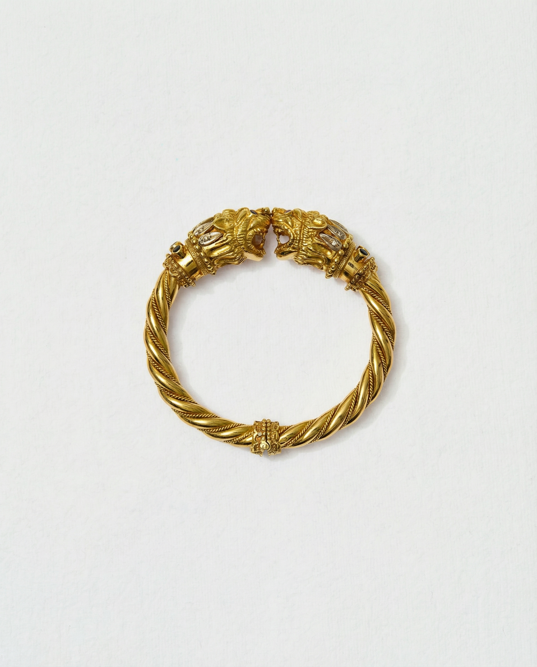 Ilias Lalaounis Chimera Head Bangle in 18K yellow gold, decorated with round white diamonds, rubies and sapphires (circa 1970s).