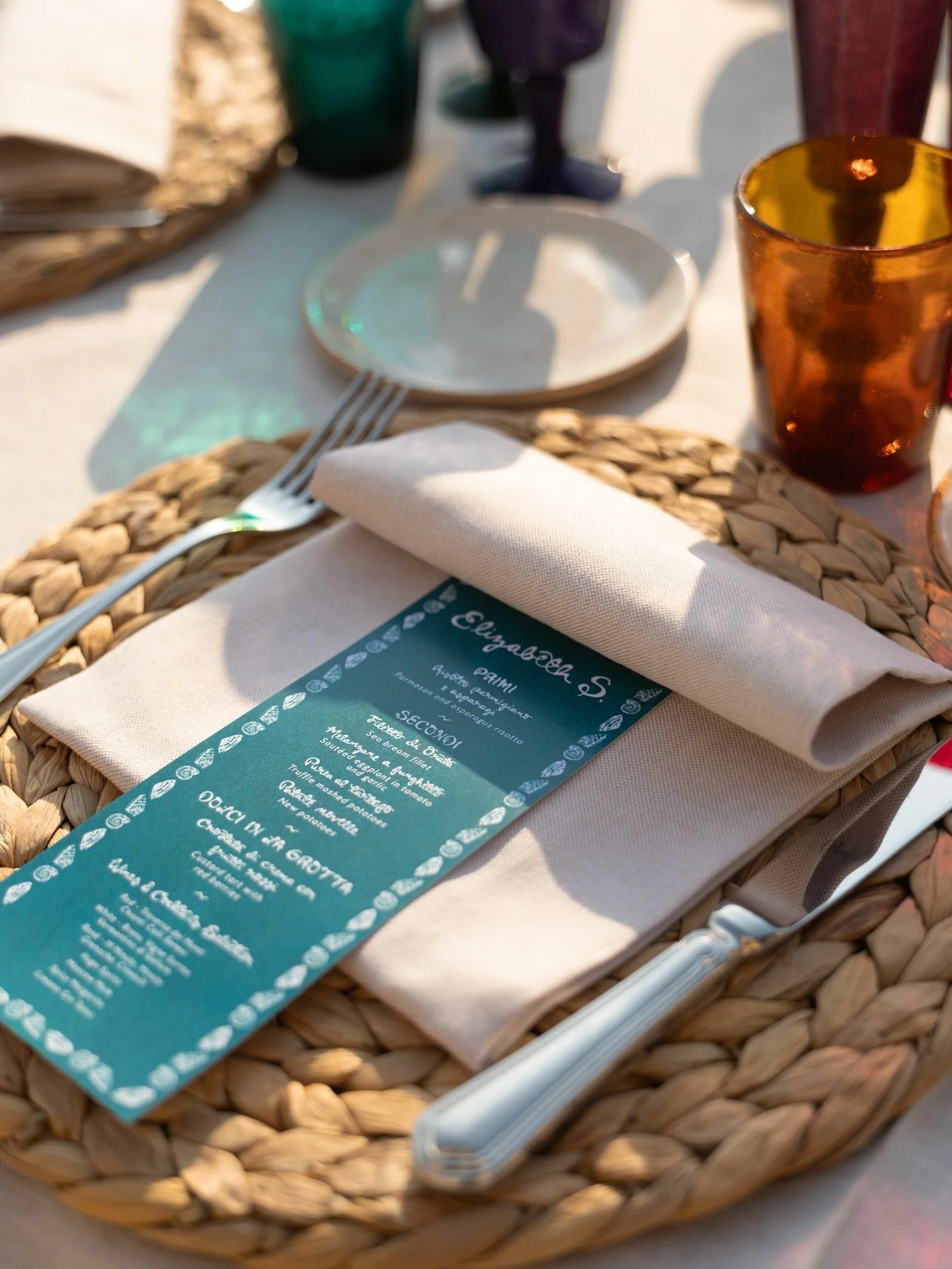 Sun-drenched details in Sardinia ~ Loved creating the day-of paper goods for this stunning seaside celebration, especially seeing my hand lettering flow from a 6ft beachside welcome night sign to a glowing projection on the cliffs above the venue 🌞?
