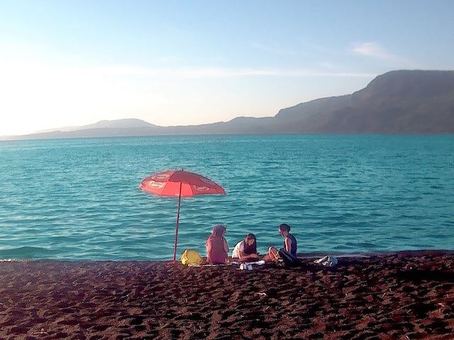 Black sand beach with family relaxing -min.jpeg