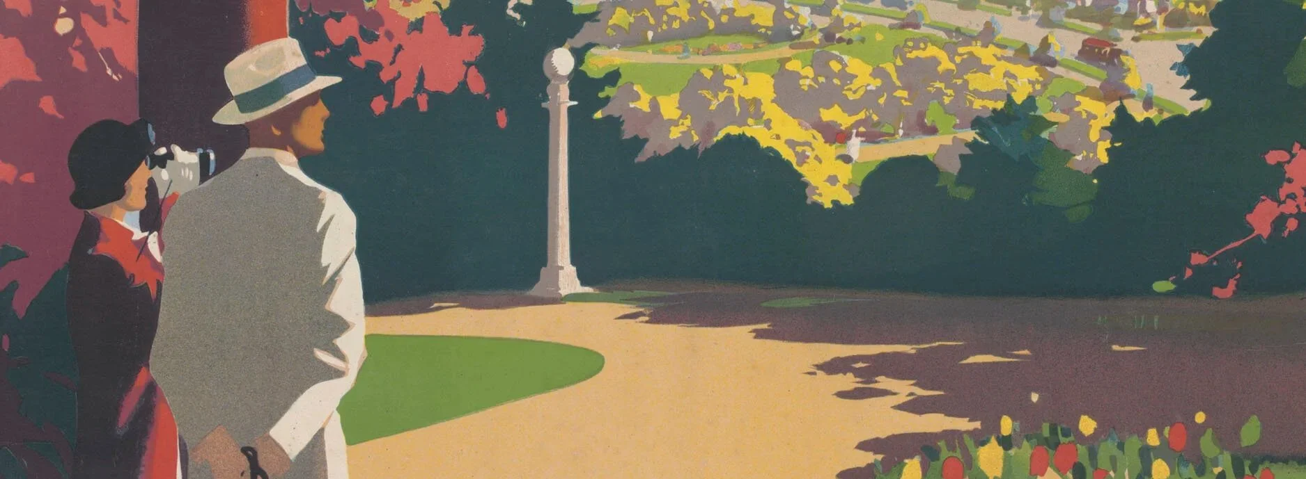 A woman and a man walking along a park pathway, shaded by trees with pink, yellow, and green leaves. The woman wears a dark dress and a hat while the man wears a light suit and a wide-brimmed hat. The scene is colorful and scenic.