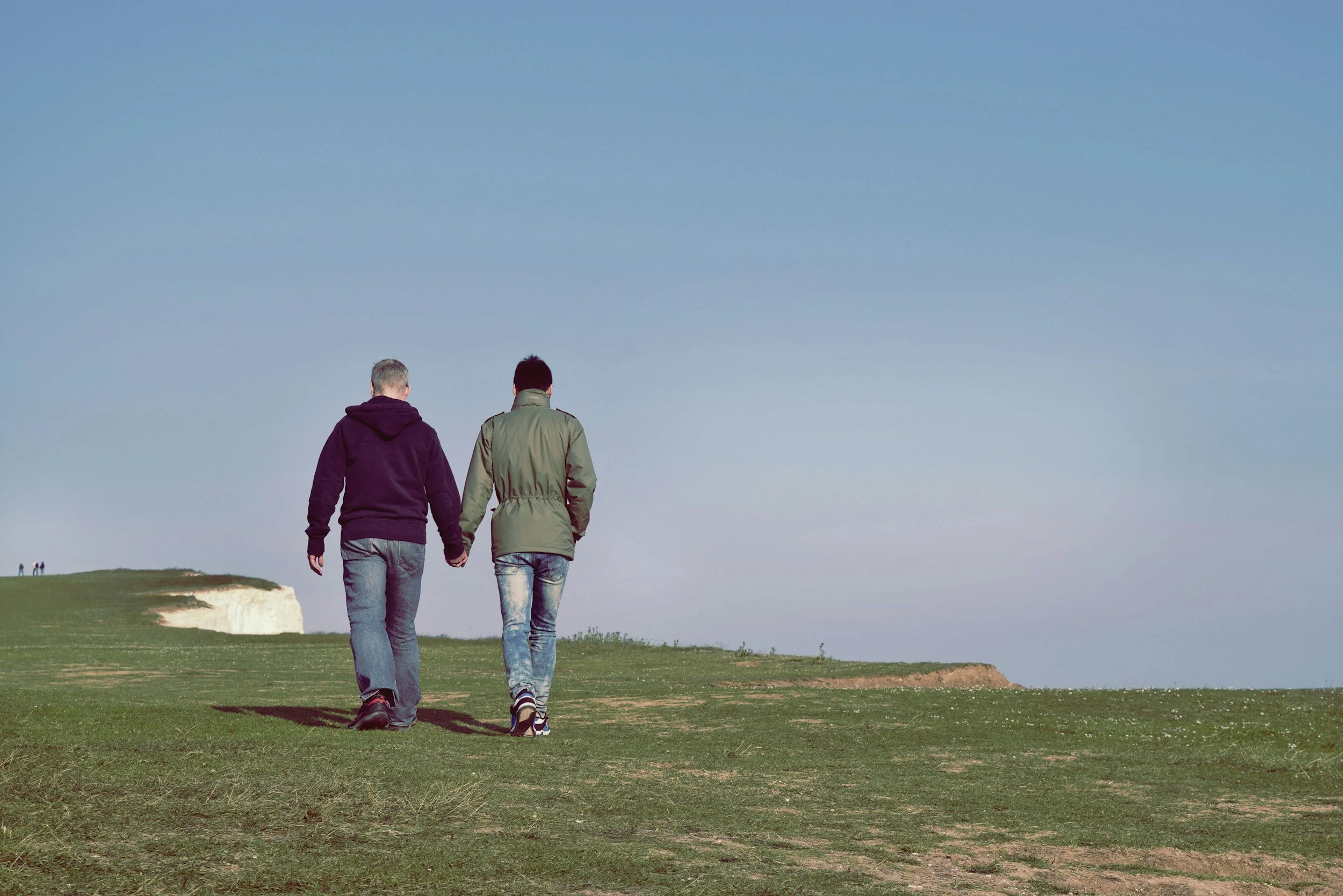 Gay couple walking to symbolize LGBTQ-affirming inclusive betrayal trauma therapy in Utah and Idaho