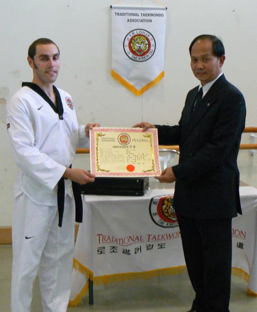 Grandmaster Loh presents Andy Hopper with his 1st Dan certificate