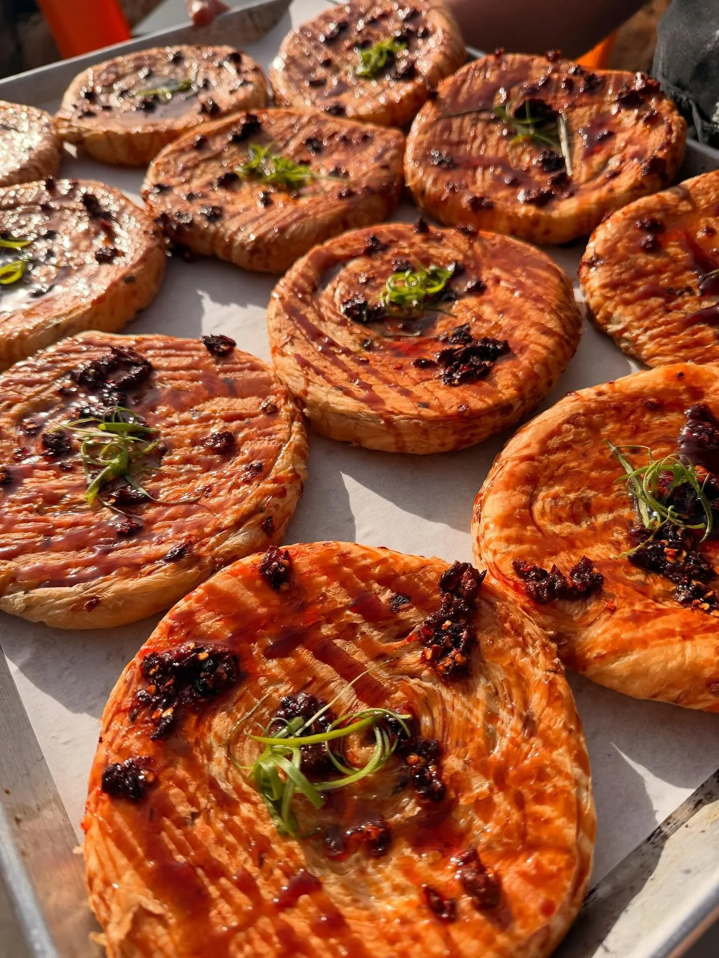 The scallion pancake- puff dough laminated with scallions, topped with soy glaze, chili crunch and fresh scallions. So simple but so damn goooooood