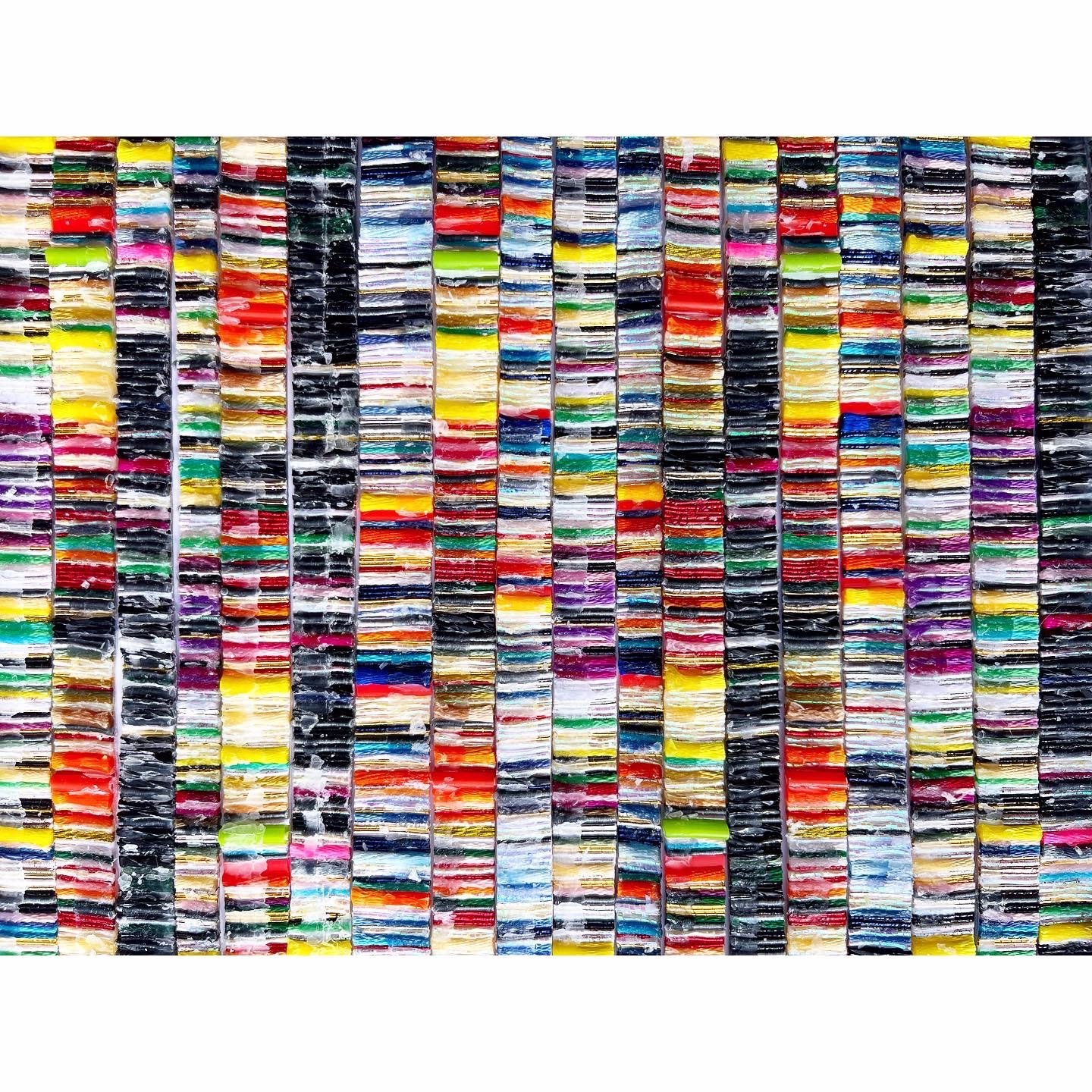 The creative process behind “Mosaic" involves threading together these diverse elements into a mosaic-like pattern. The strips of textile, rubber, and copper are arranged side by side, creating an abstract tapestry of colors, shapes, and textures. E