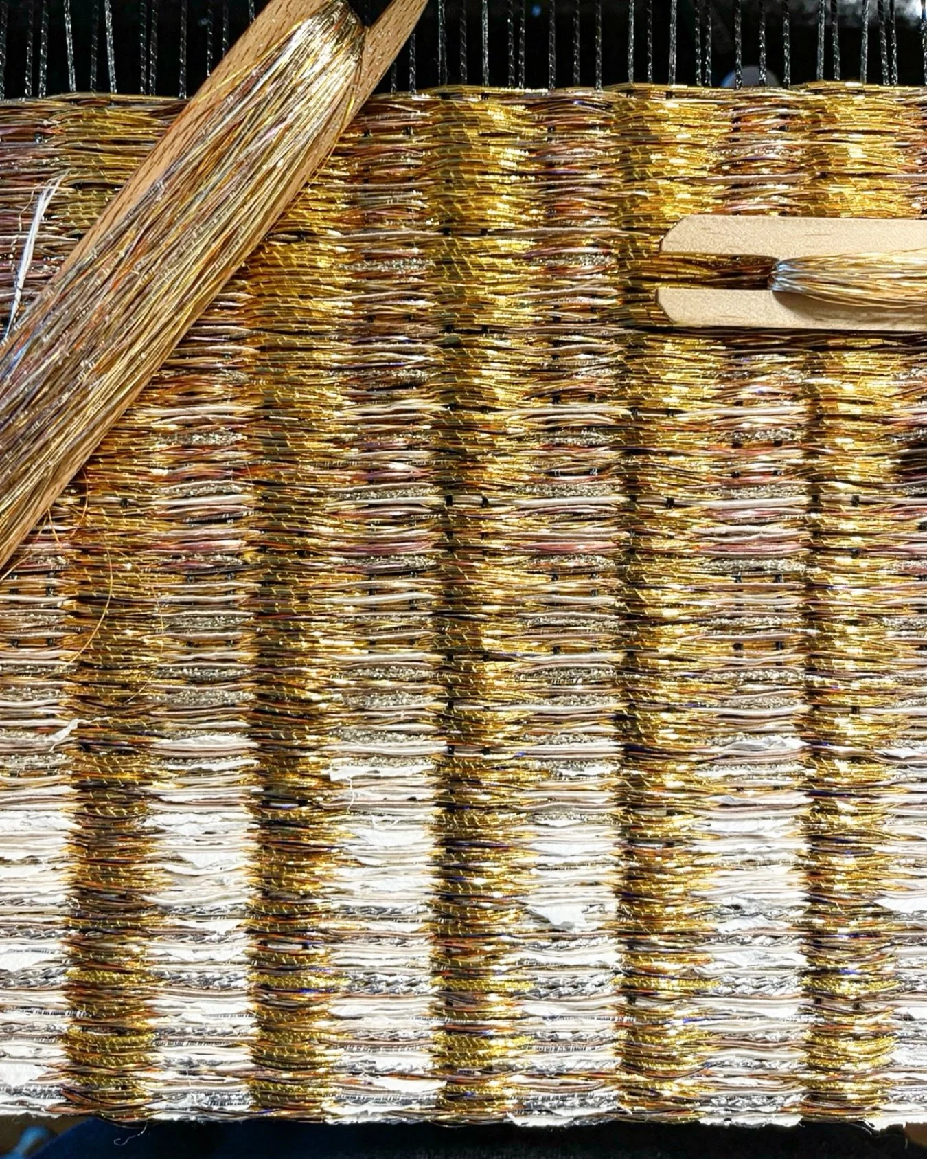 Handwoven with recycled metal, coated silk, tinted aluminum, and 24k gold thread, this 30 &times; 30 inch gradient panel shifts into near three-dimensionality through light and reflection.

#contemporarytextileart  #preciousmetals #collectibleart #ny