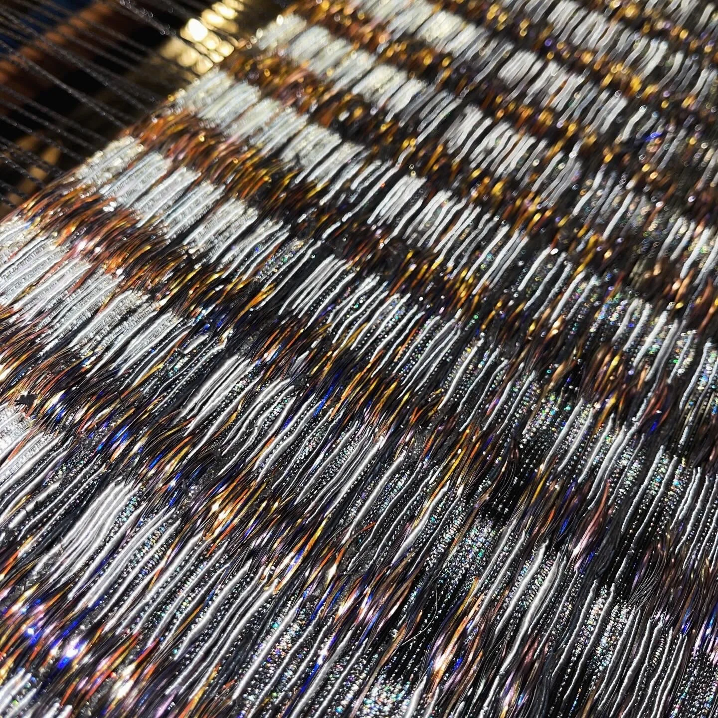 A closer look at the gradient: charcoal dissolves into silver, fading into white, as black threads emerge as gold.⁠
Each piece in this contemporary fiber art series is entirely handmade, composed of thousands of individually selected threads to achie