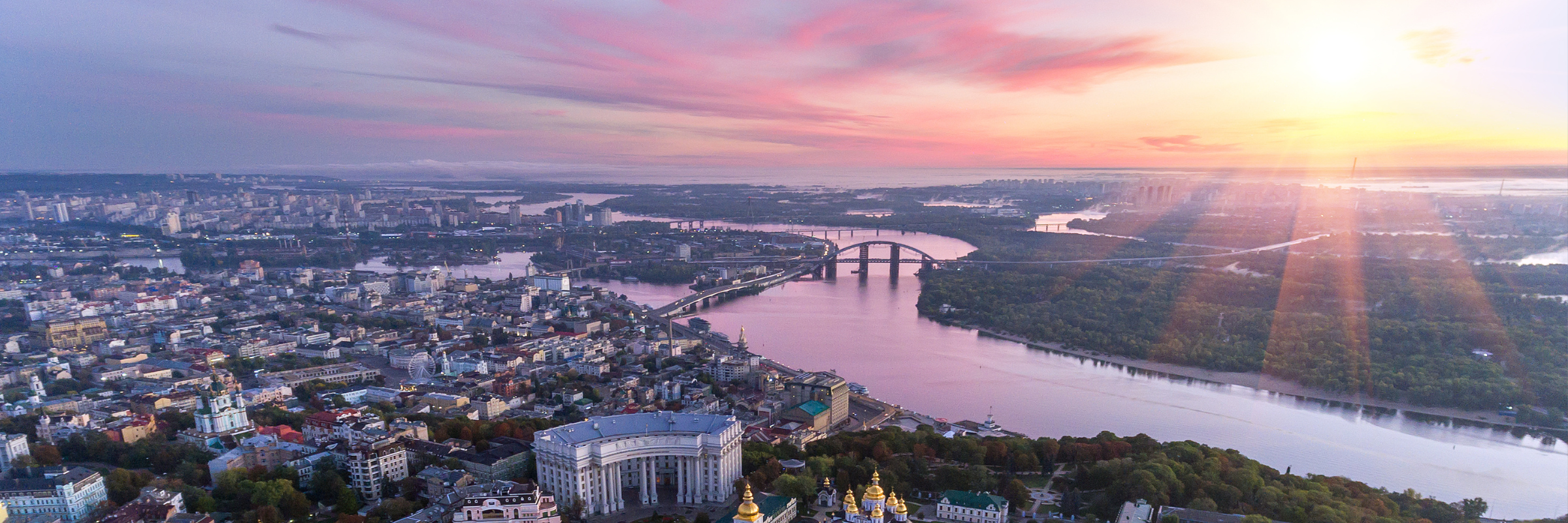 Wide angle view of Kyiv Ukraine with the sun setting over the city