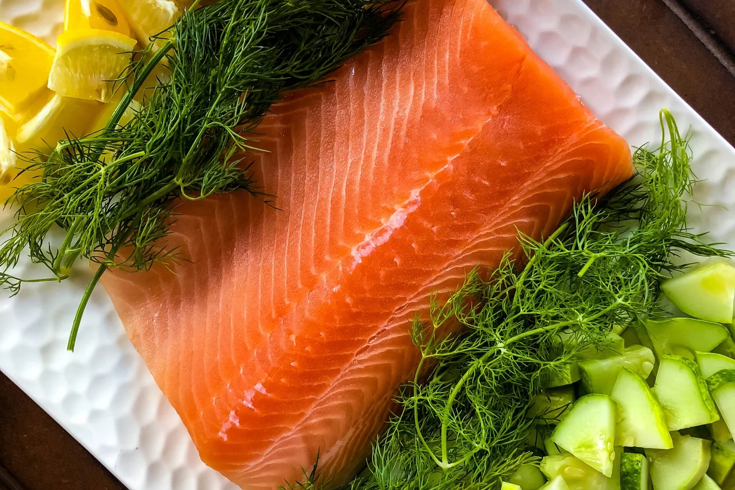 A perfectly seared salmon fillet topped with a vibrant cucumber and dill relish