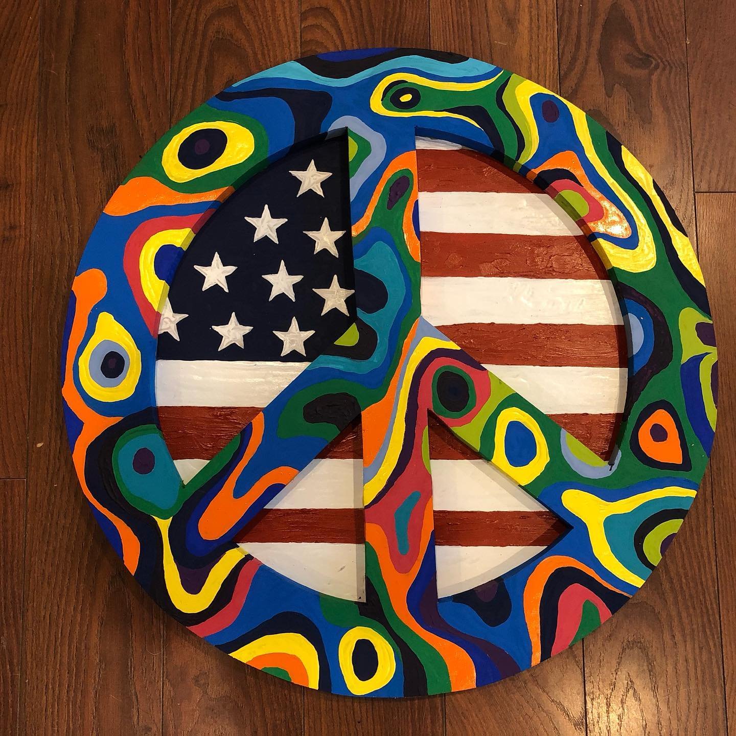 First #layered sign i&rsquo;ve made. Pretty happy with the result! I call this one &ldquo;#AllThePrettyColors.&rdquo; #Acrylic on wood, 22&rdquo; in diameter, $80. #sturgillsimpsonlyrics #usa #patriotic #peacesign #peaceofart #peaceofartdecor