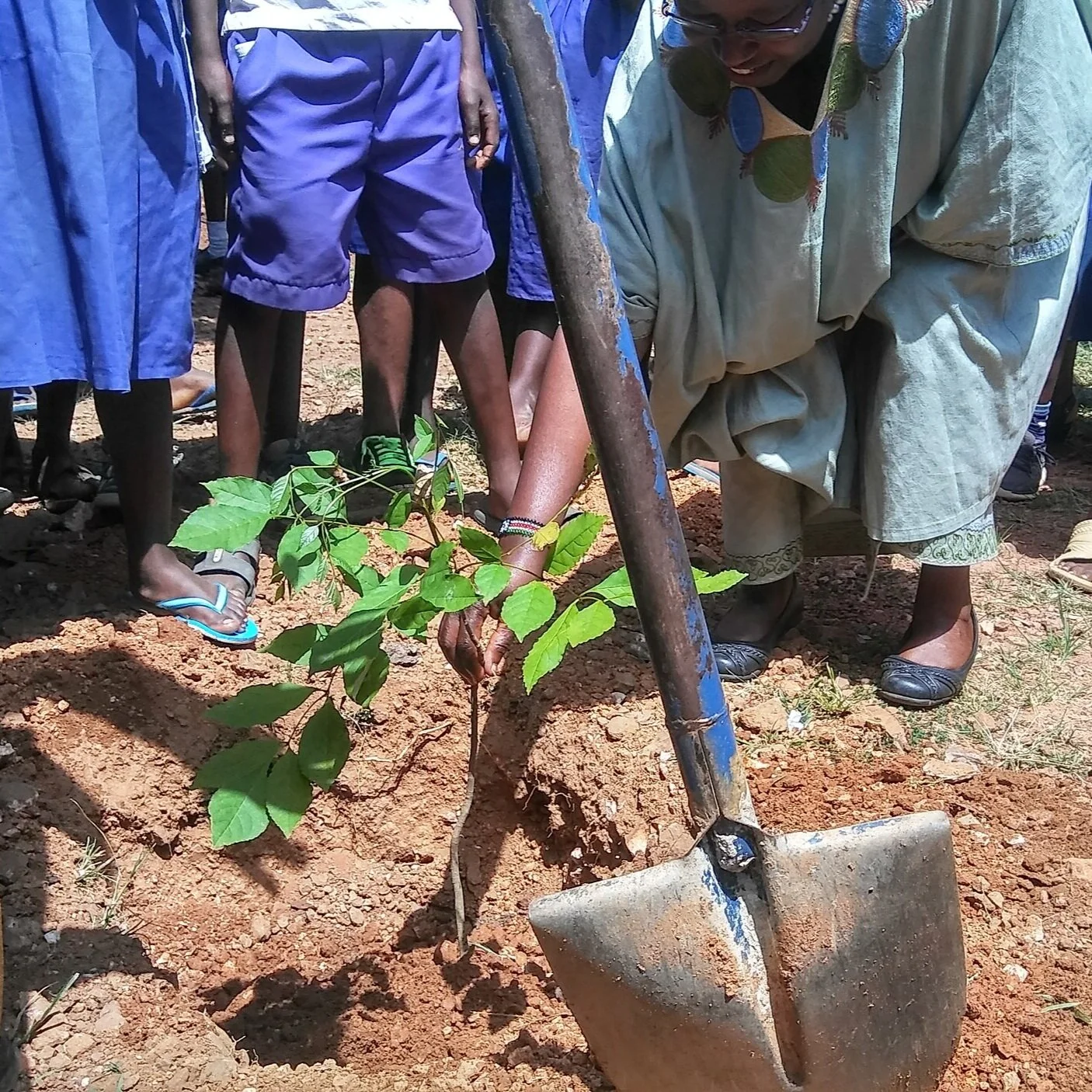 Grace+Planting+Trees+with+Elementary+Students+in+Kenya.jpg