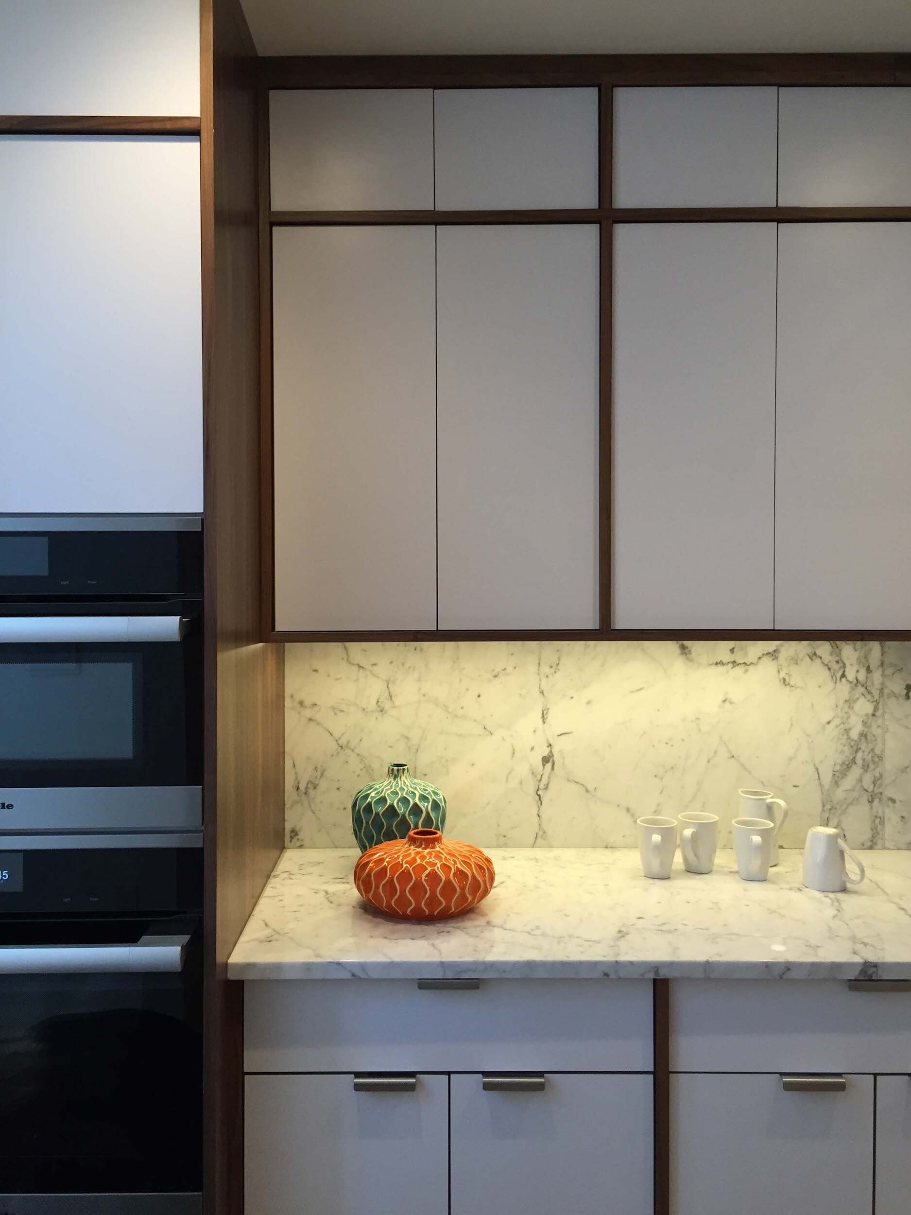 bergstrom-matte-white-walnut-kitchen-cabinets-stainless-tab-pull-03.jpg