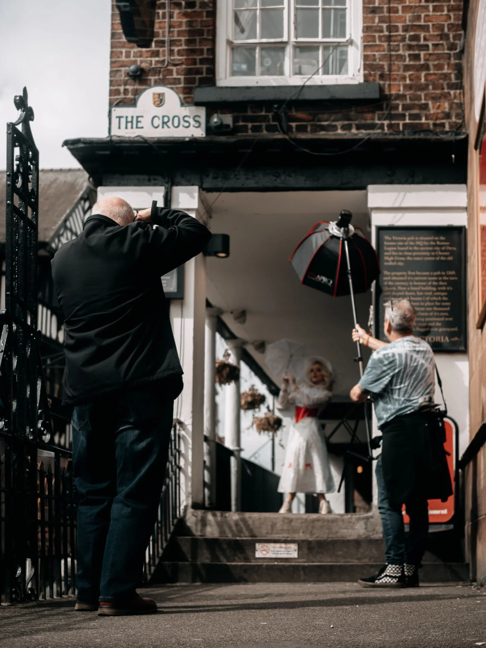 Editorial photographers directing a model during an on-location fashion shoot in Los Angeles
