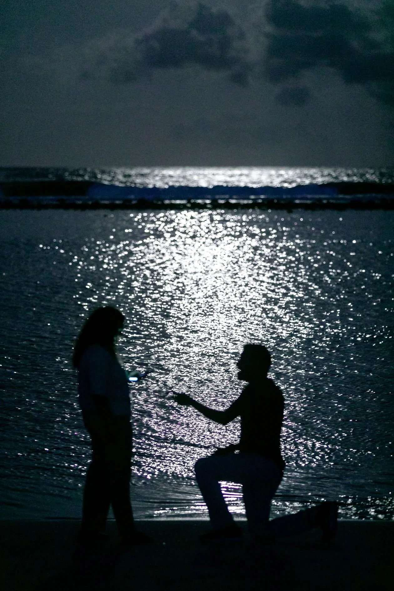 Romantic beach proposal at sunset photographed by a Los Angeles proposal photographer
