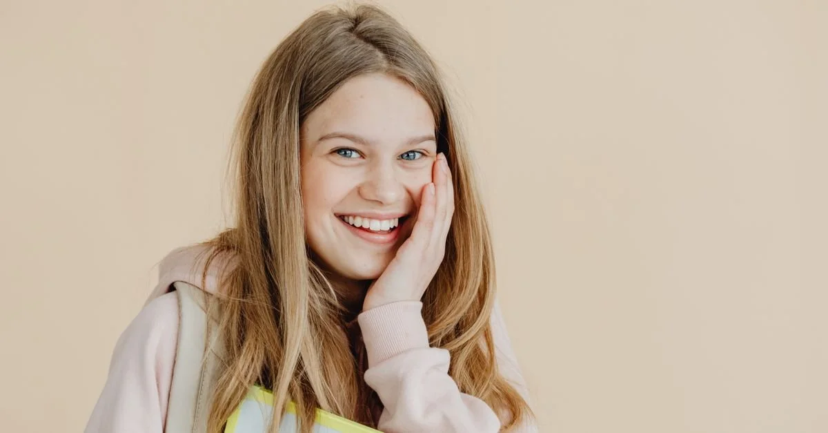 Senior girl smiling during an outdoor senior portrait session in Los Angeles