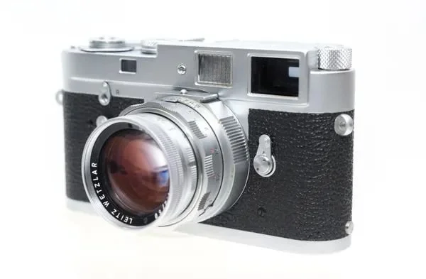Front of a Leica M camera showing the viewfinder and rangefinder windows used to focus a Leica rangefinder