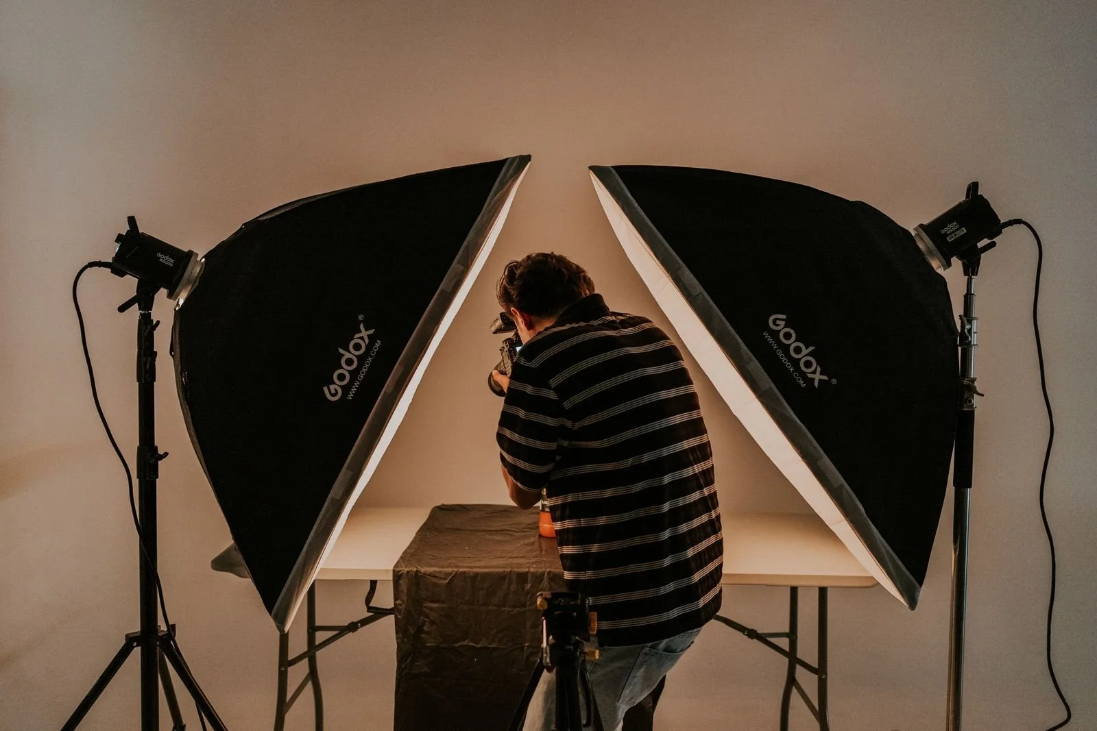 Celebrity photographer working with camera and studio lighting in Los Angeles