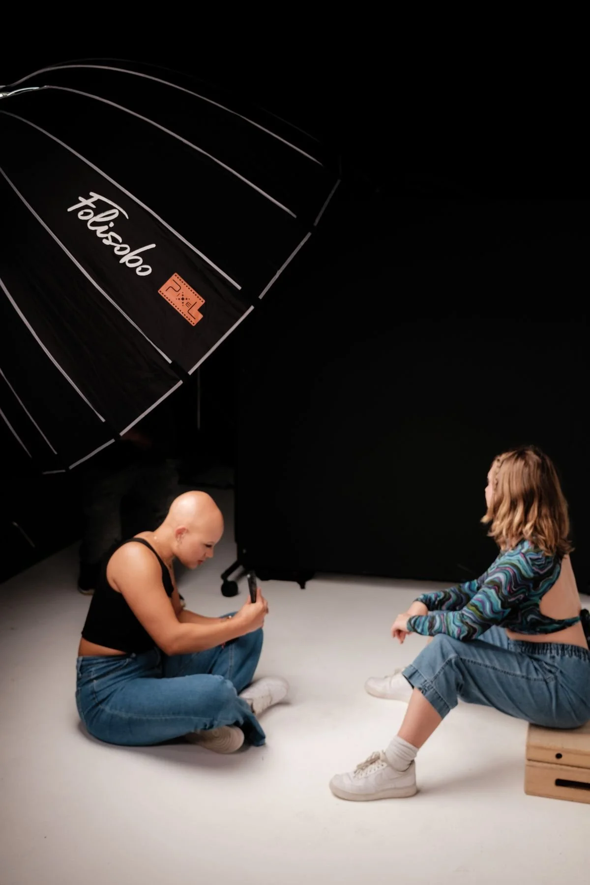 Dating profile photographer directing a portrait session with professional studio lighting in Los Angeles
