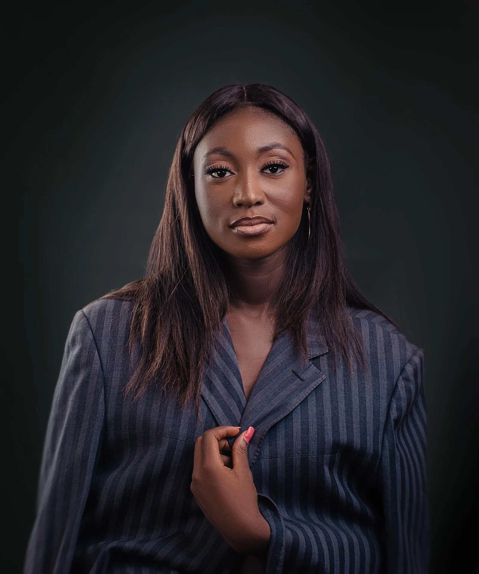 Executive portrait of a businesswoman in a pinstripe suit by a corporate photographer for businesses