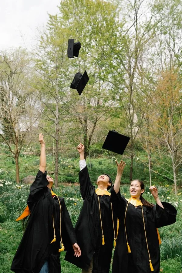Graduation caps thrown in the air at a senior portrait celebration in Los Angeles