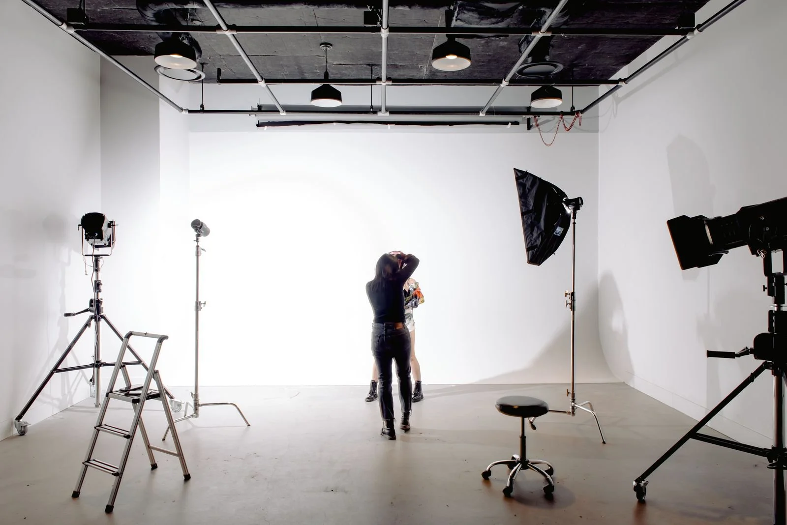 Commercial photographer directing a model during a Los Angeles studio brand shoot