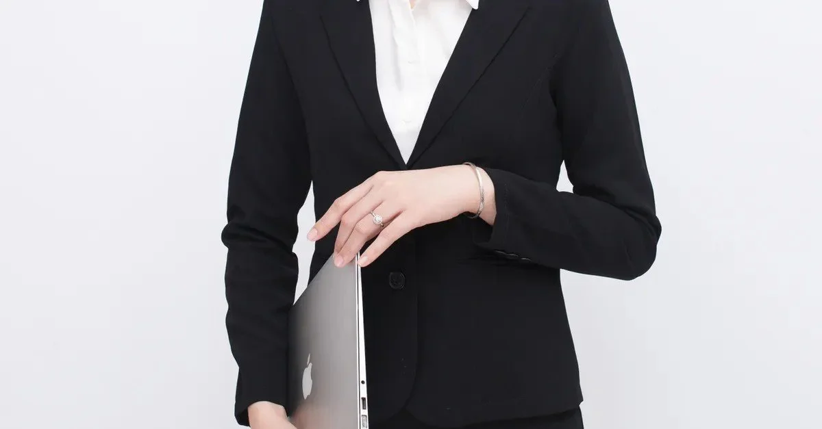 Elegant businesswoman holding a laptop in a branding portrait