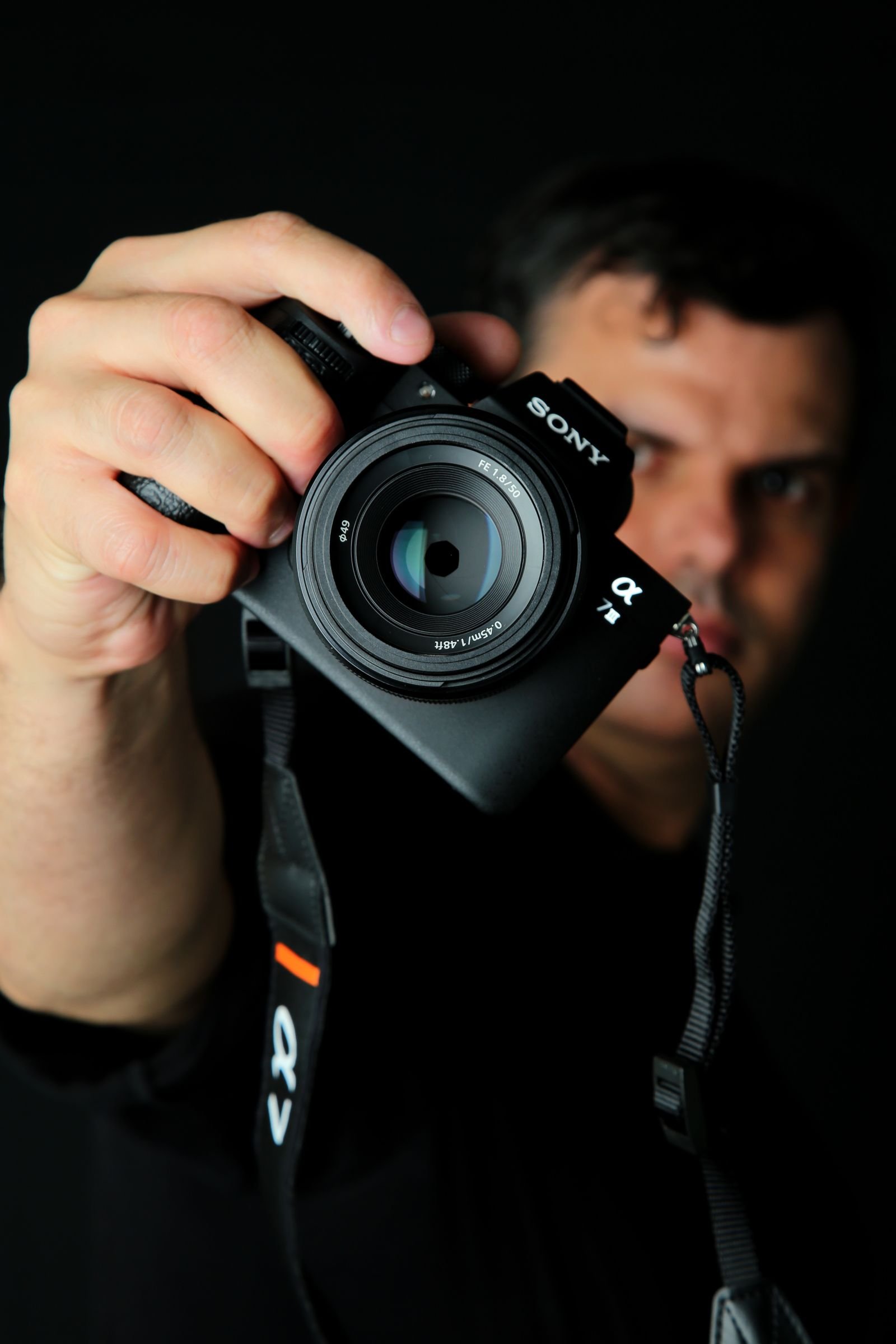 Photographer holding a camera in a close-up portrait, famous Los Angeles photographers