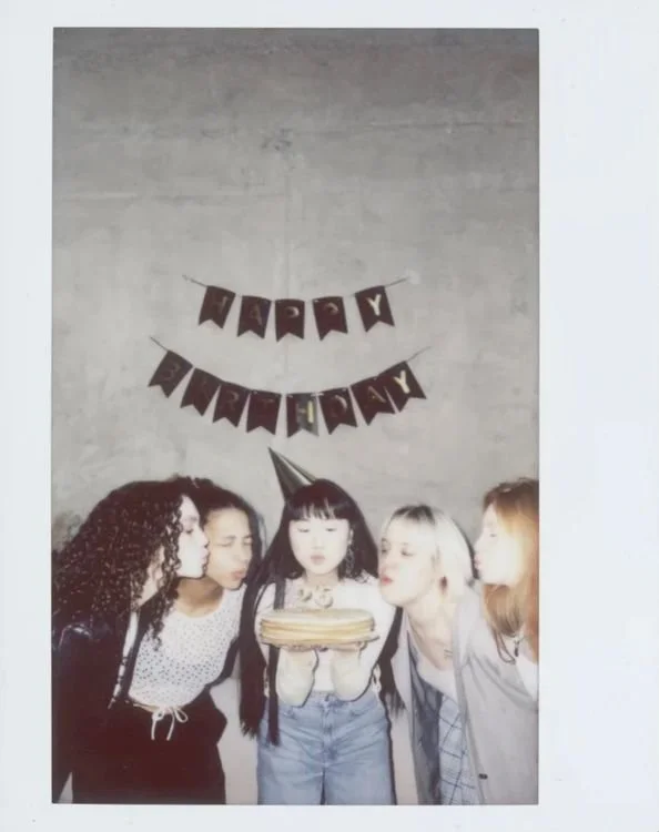 Group of young friends celebrating together at a milestone birthday party