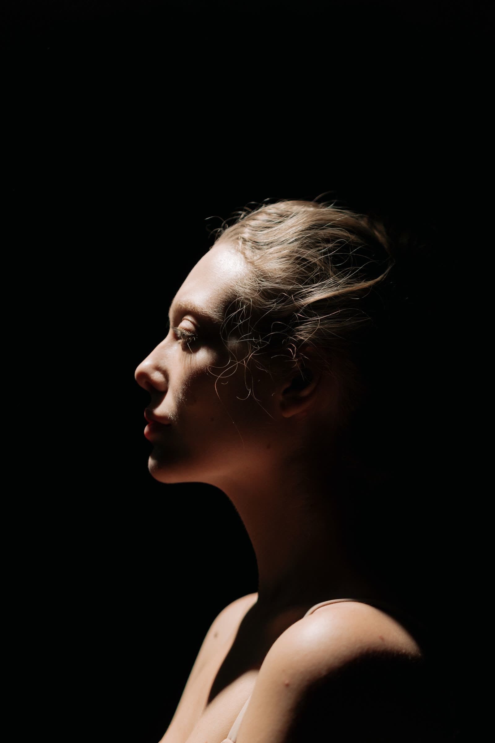Close-up fashion portrait showing natural skin texture preserved after professional dodge and burn retouching