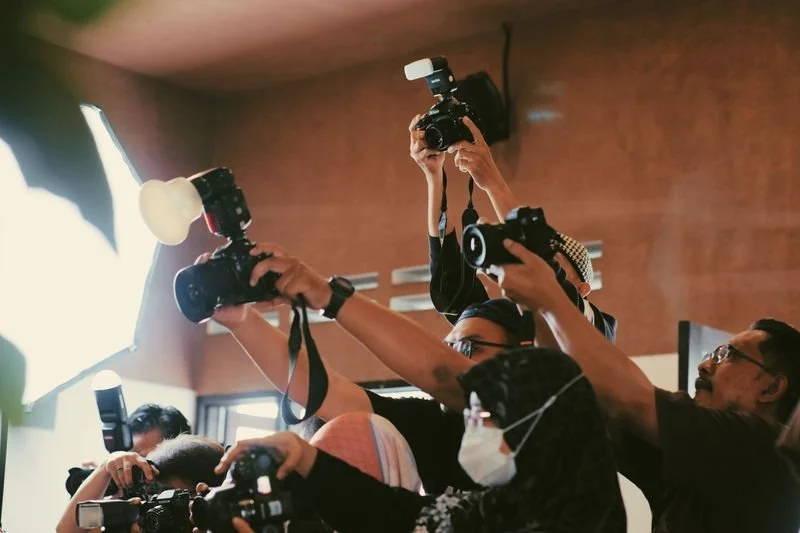 Photographers capturing an indoor corporate event