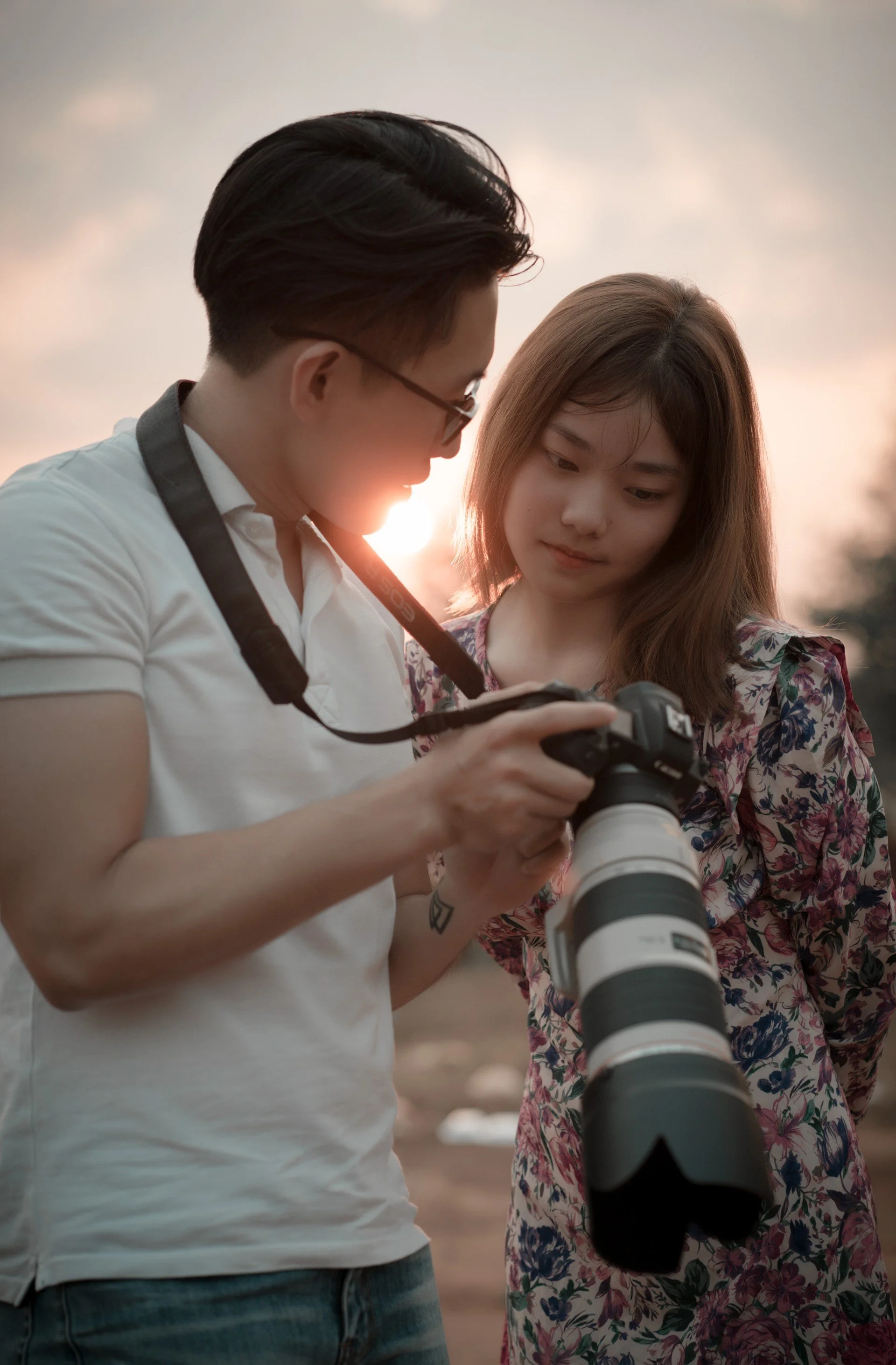 Photographer and model reviewing shots during a golden-hour outdoor photoshoot in Los Angeles