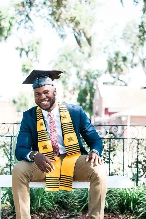 Smiling graduate in cap and gown with stole posing for a graduation portrait in Los Angeles