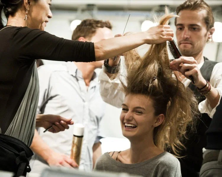 Backstage hair and makeup preparation at a fashion show