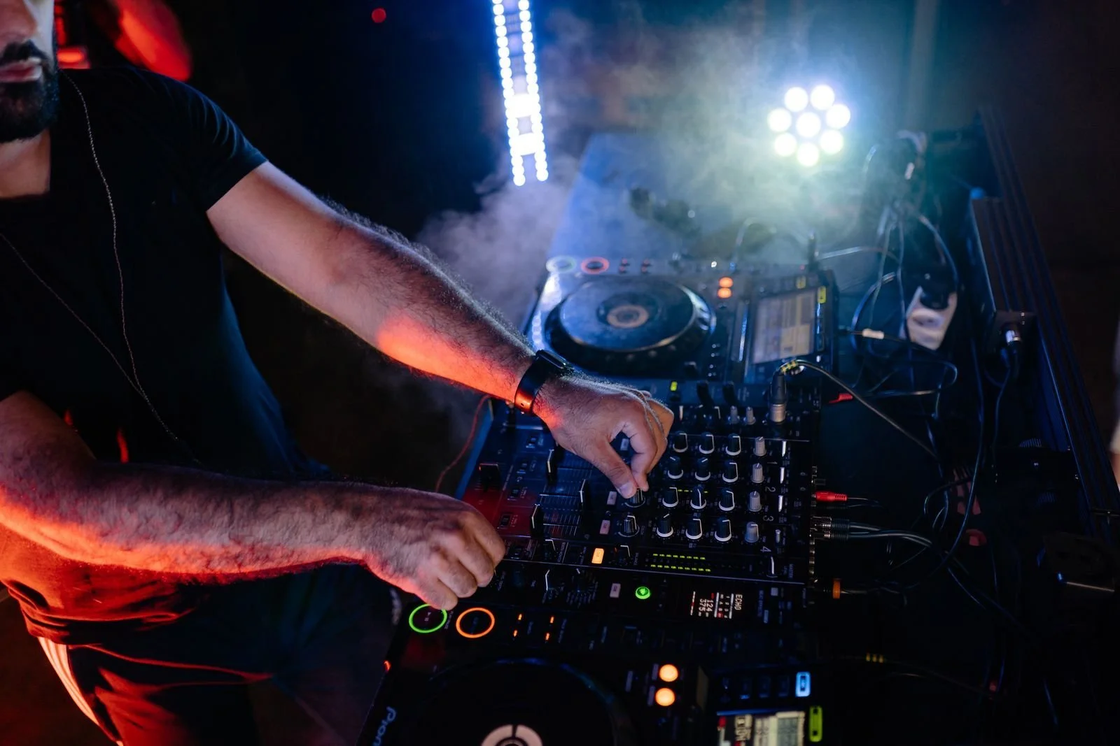 Nightclub photography lighting: dance floor bathed in colored club lights during a live set