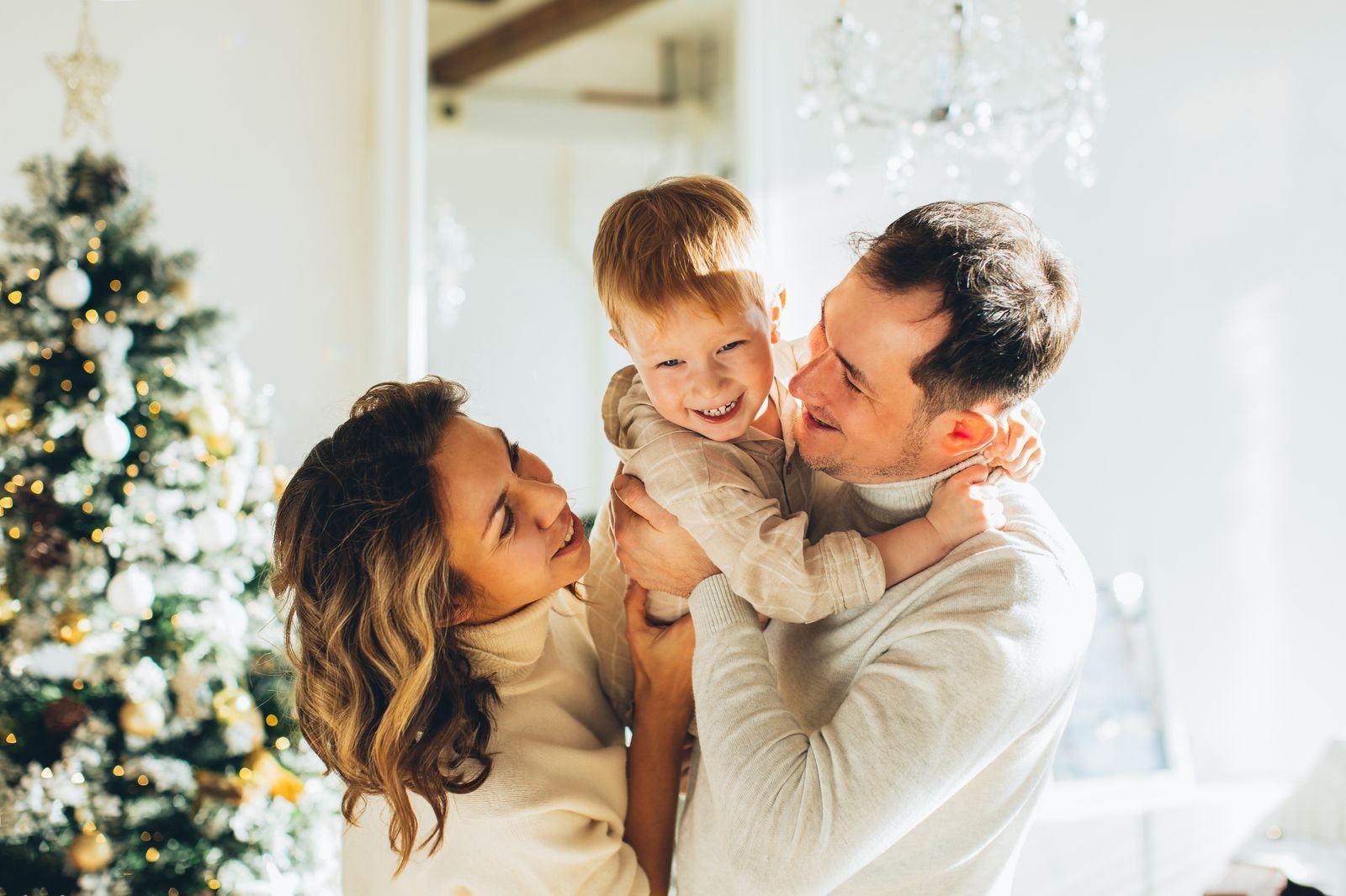 Warm lamplight and window light mixing during a holiday family portrait session