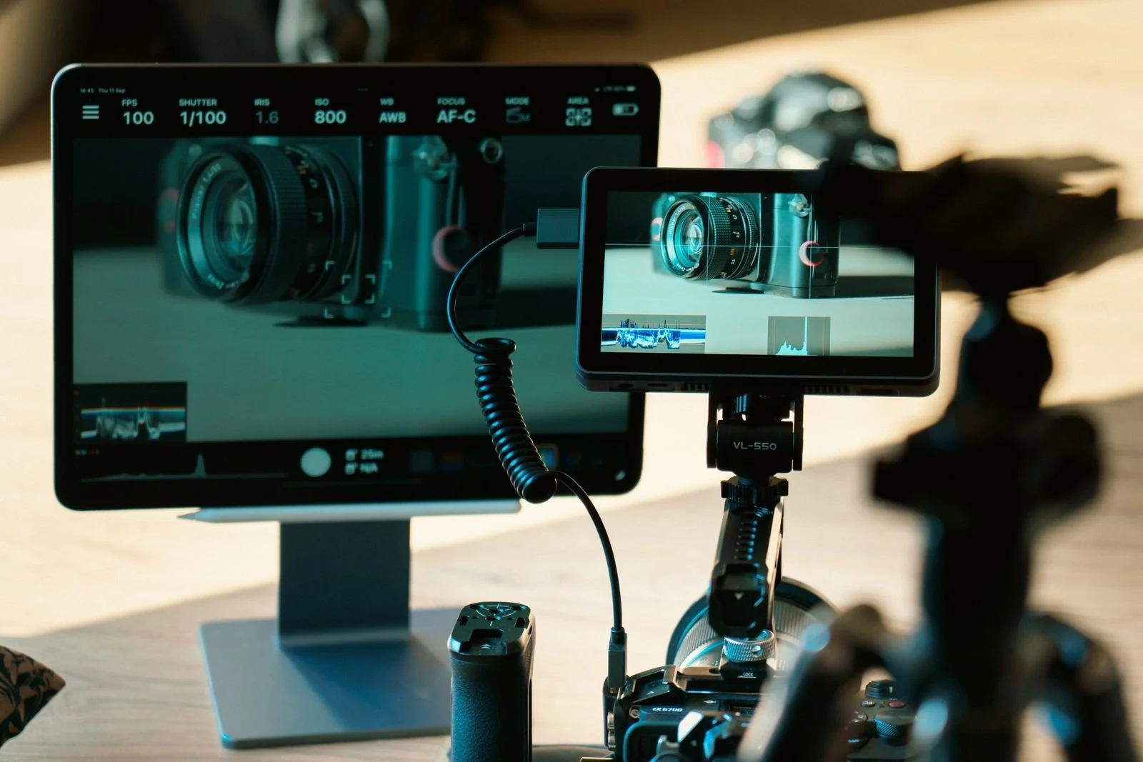 Photographer reviewing tethered shooting workflow images on a large studio monitor setup