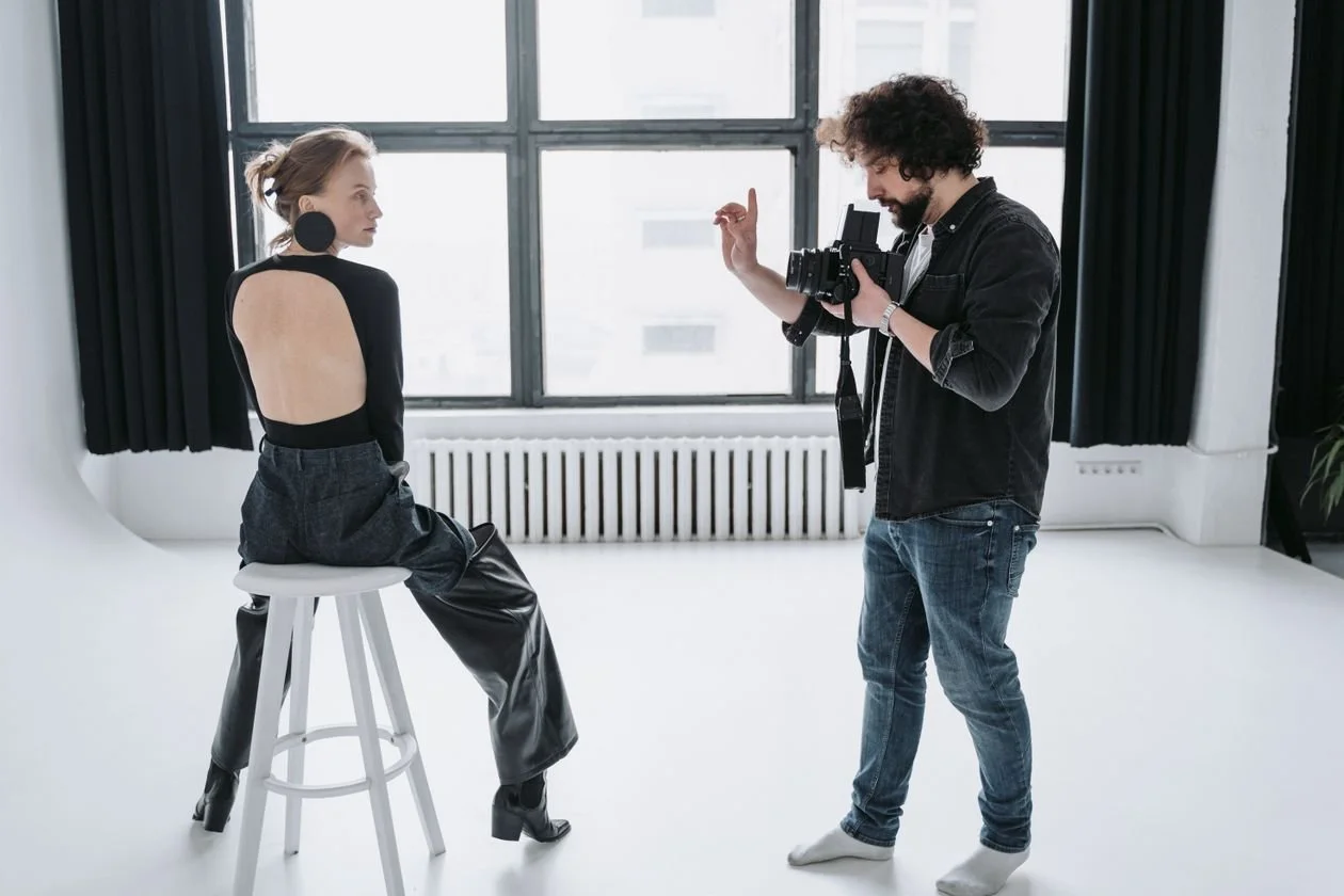 Fashion photographer directing a model during a Los Angeles studio fashion photography session