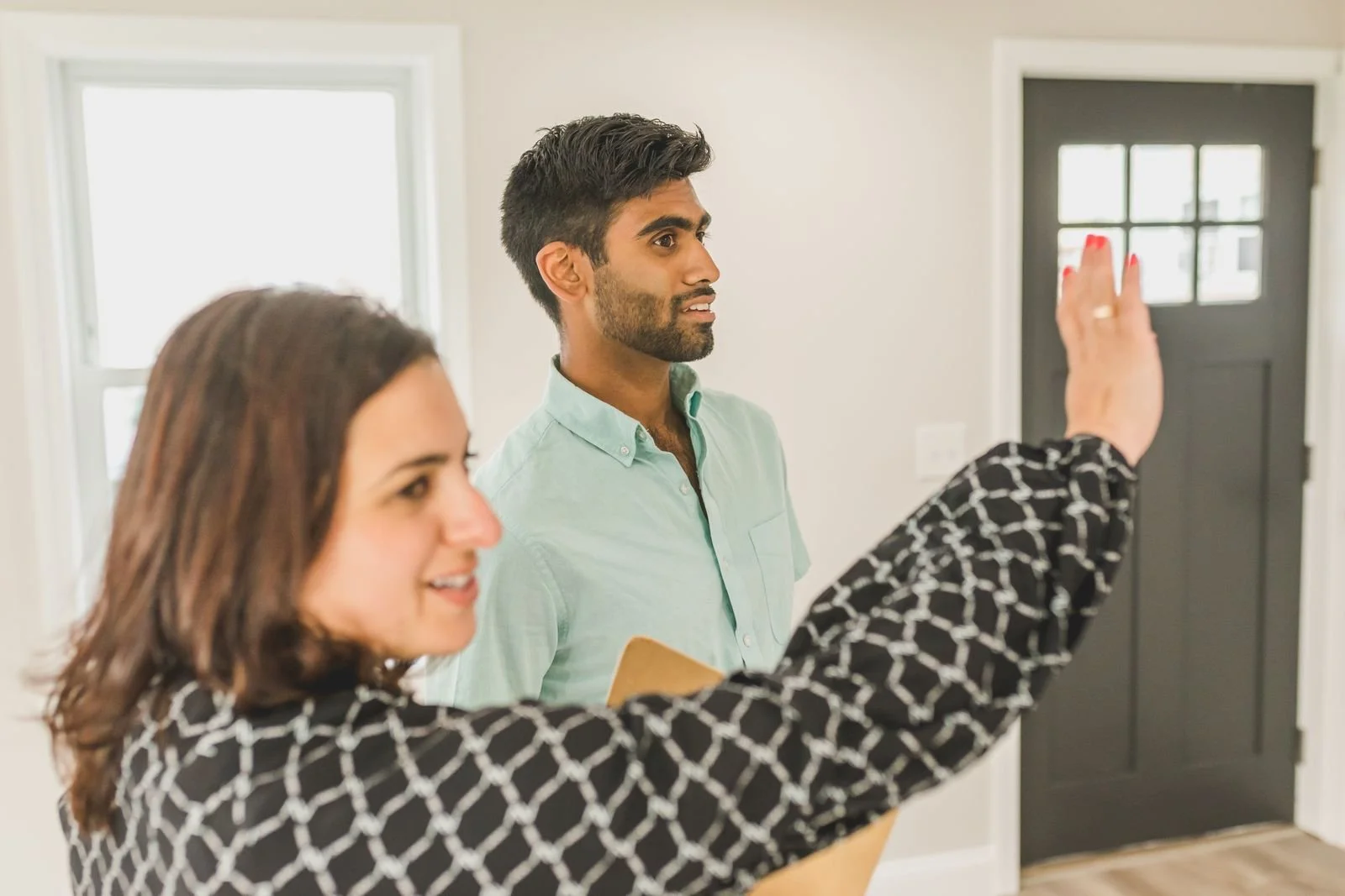 Real estate agent walking a buyer through a professionally photographed Los Angeles home