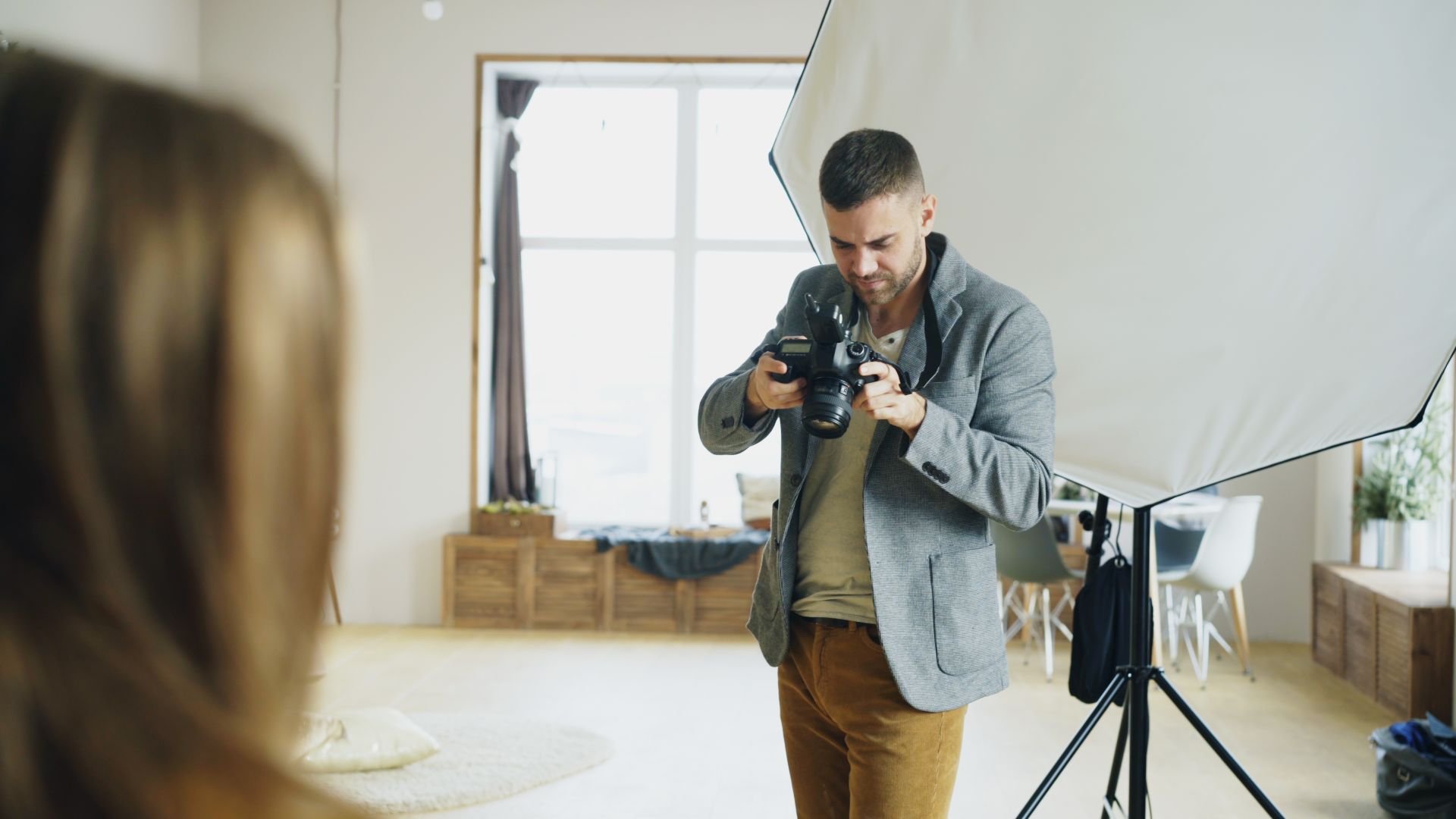 Photographer reviewing camera settings during a photoshoot setup in Los Angeles