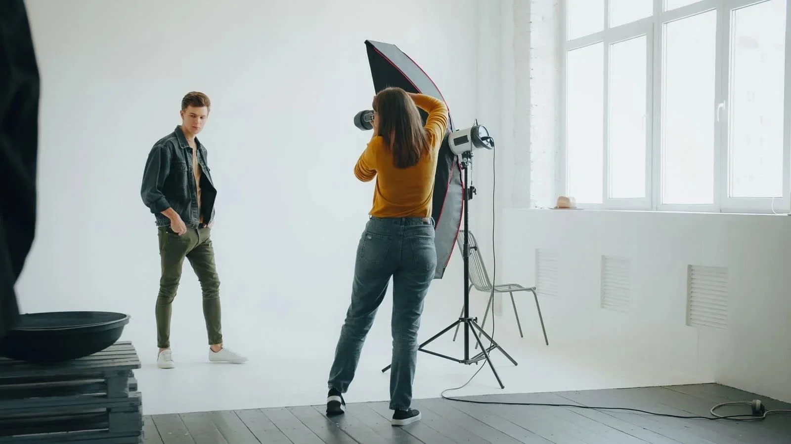 Headshot photography lighting setup: photographer shooting a portrait session with studio strobe and large softbox