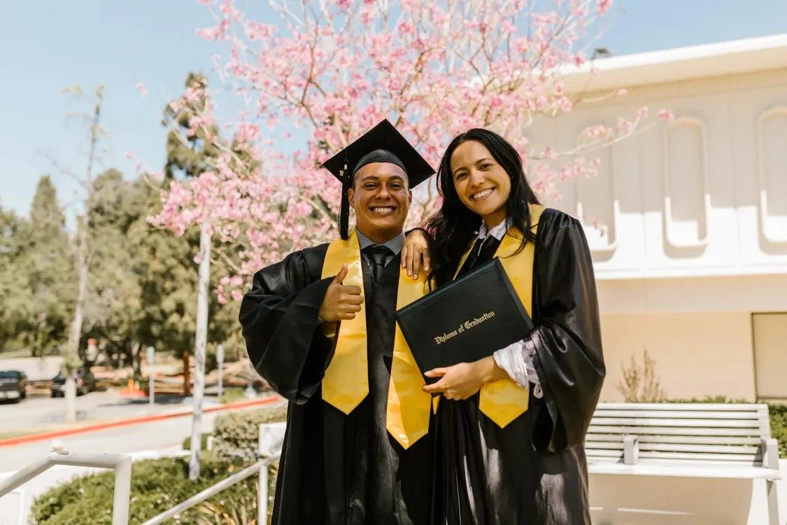 Graduation photographer Los Angeles portrait of graduates in caps and gowns holding diplomas