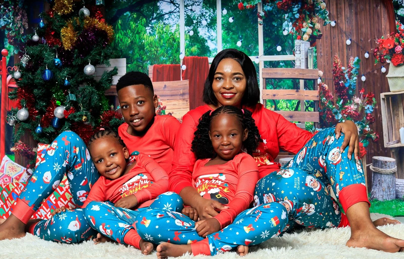Festive family portrait with a Christmas tree, the kind of final image a holiday mini session workflow delivers
