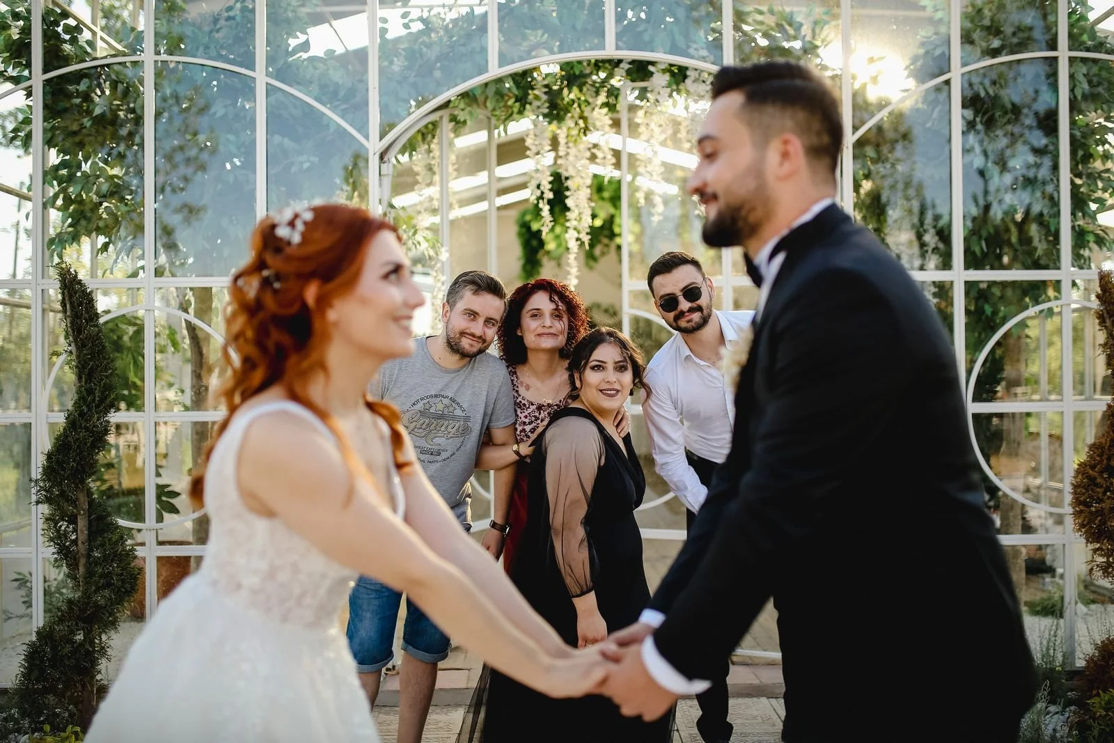Bride and groom posing with wedding guests, the formal family portraits that full-day wedding photography coverage includes