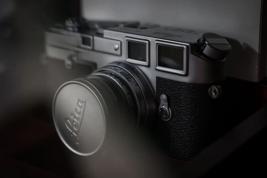 Close-up of a Leica M rangefinder camera showing the focus distance scale on the lens, used when learning how to focus a Leica rangefinder