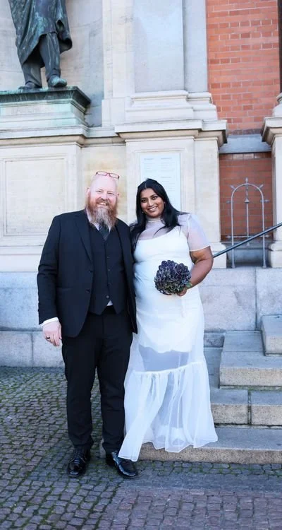 Elegant wedding couple posing in front of a historic Beverly Hills building after their courthouse ceremony