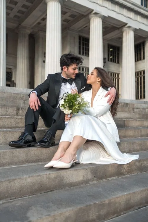 Bride and groom in formal attire on grand outdoor steps at their Beverly Hills courthouse wedding
