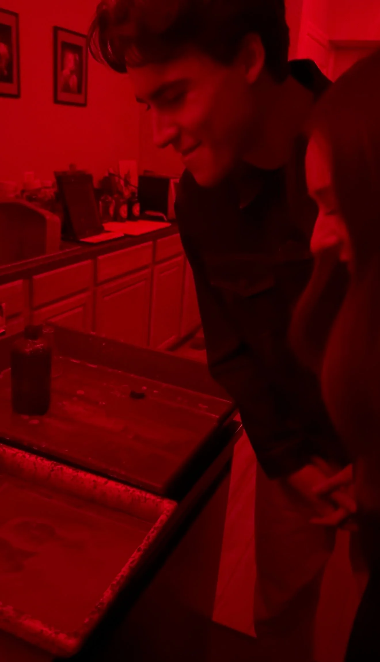 Viewing tintype development in the darkroom near Nashville