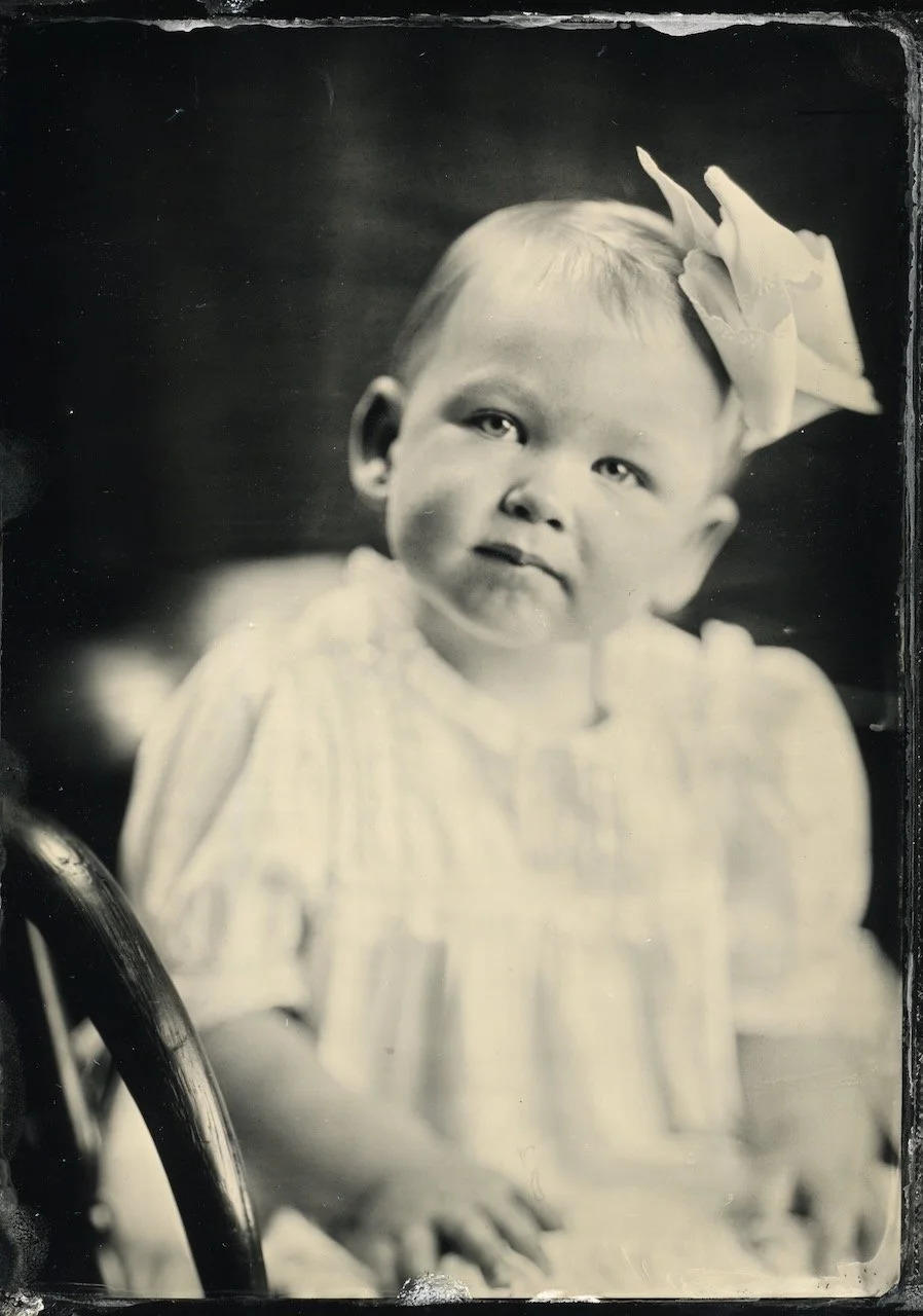 Tintype portrait of a baby in a wooden chair, wet plate photograph by Blake Wylie near Nashville