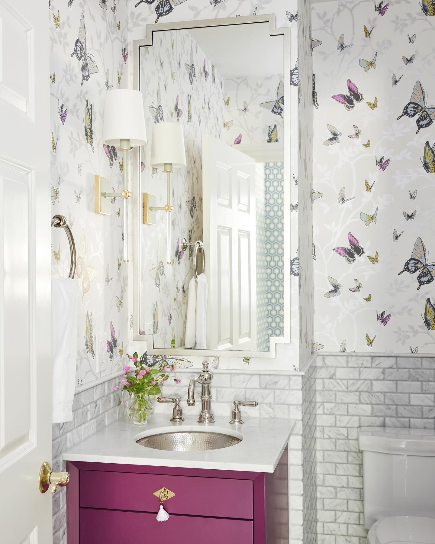What&rsquo;s your favorite element of this sweet powder bath? We can&rsquo;t decide! The butterfly wallpaper or the cranberry colored vanity?!? Oh yeah, and the lighting, the mirror, or the hammered metal sink. There&rsquo;s too many gorgeous element