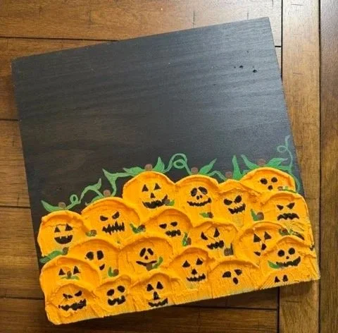 Jack-o-lantern spackle painting on wood
